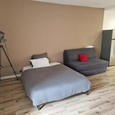 a bed and a chair in a room at F1 cap 3000 in Saint-Laurent-du-Var