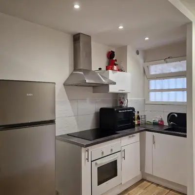 a kitchen with a stainless steel refrigerator and a microwave at F1 cap 3000 in Saint-Laurent-du-Var