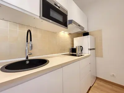 a kitchen with a sink and a refrigerator at Nestor&Jeeves - SEA AND SUN - Central - Close sea in Nice
