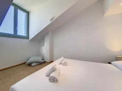 a bedroom with a large white bed with towels on it at Nestor&Jeeves - NICE TO MEET YOU - Top floor - Central in Nice
