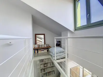 a staircase in a house with a window and books at Nestor&Jeeves - NICE TO MEET YOU - Top floor - Central in Nice