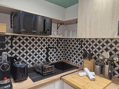 a kitchen counter with a sink and a microwave at PASTO DROITE Appartement Nice 6P in Nice