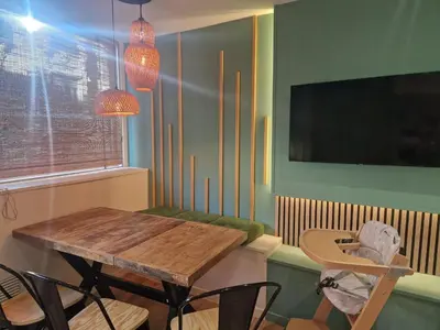 a dining room with a wooden table and chairs at PASTO DROITE Appartement Nice 6P in Nice