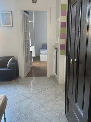 a hallway with a living room with a couch and a door at La casa in Nice