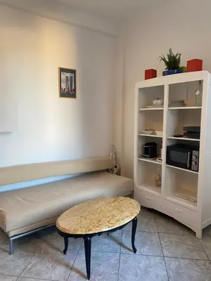 a room with a bed and a table and a shelf at La casa in Nice