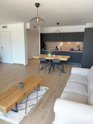 a living room with a couch and a table at Seaside Azur in Saint-Laurent-du-Var