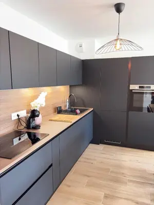 a kitchen with black cabinets and a counter top at Seaside Azur in Saint-Laurent-du-Var