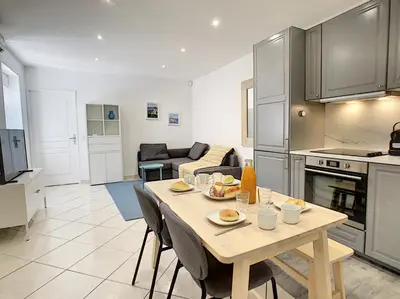 a kitchen and living room with a table and chairs at Nestor&Jeeves - URBAN SUN - Central - Close sea in Nice