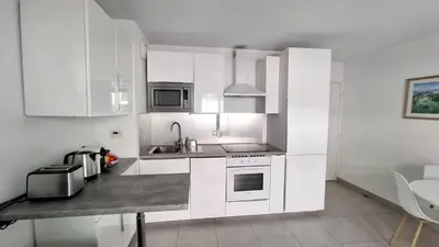 a kitchen with white cabinets and a counter top at Beautiful 43m2 with two double beds everything nearby in Nice