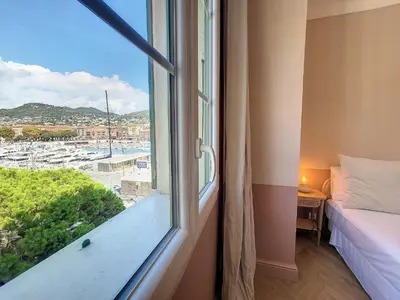 a bedroom with a window with a view of a harbor at Nestor&Jeeves - PORT LYMPIA - Close Old Town - Port Area in Nice