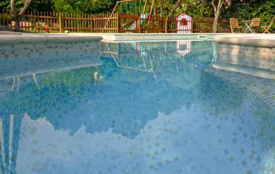 a swimming pool with a reflection in the water at Gorgeous Home In La Gaude in La Gaude
