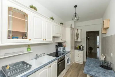 a kitchen with white cabinets and a sink and a dishwasher at Breathtaking panoramic view of Nice ! in Nice