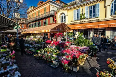 a group of people walking around a market with flowers at Nestor&Jeeves - L'OLYMPIC - Central - Very close sea in Nice