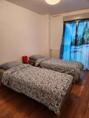 two beds sitting in a room with a window at Charmant 2 pièces, centre ville & proche gare in Nice