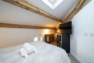 a bedroom with a bed with two towels on it at Appartement Original cœur de ville -AC- in Nice