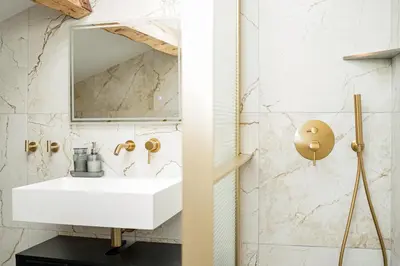 a bathroom with a white sink and a mirror at Appartement Original cœur de ville -AC- in Nice