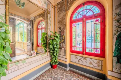 a room with stained glass windows and a plant at Appartement Original cœur de ville -AC- in Nice