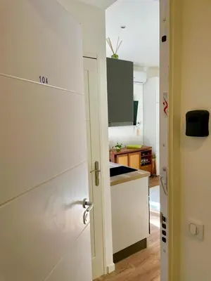 an open door to a kitchen with a counter top at Under the Citrus Trees in Nice