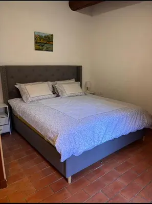 a large bed in a room with at Morning Coffee & Cobblestones - A True French Village Stay in Villefranche-sur-Mer