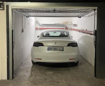 a white car is parked in a garage at Pleine vue mer au calme - Parking, Piscine, Tennis in Nice