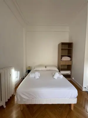 a bedroom with a large white bed with white sheets at Large Studio 7 minutes from Beach in Nice