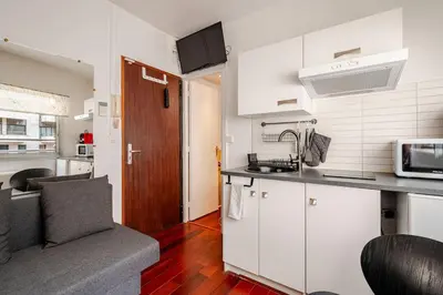 a kitchen with white cabinets and a counter top at studette a coté de la mer et la promenade in Nice