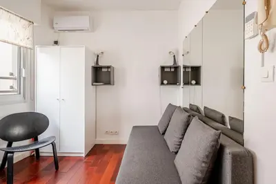 a living room with a couch and a chair at studette a coté de la mer et la promenade in Nice