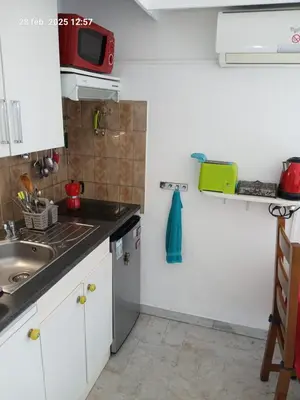 a small kitchen with a sink and a microwave at Studio Proche mer Nice in Nice