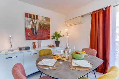 a dining room with a table and chairs at FRANCIA AZUR AP4483 by RIVIERA HOLIDAY HOMES in Nice