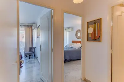 a bedroom with a bed and a door leading into a room at FRANCIA AZUR AP4483 by RIVIERA HOLIDAY HOMES in Nice