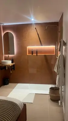 a bathroom with a shower and a sink and a bed at Suite orientale avec baignoire balnéo in Cagnes-sur-Mer