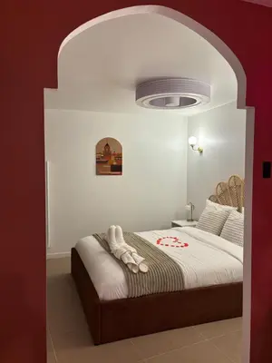 a bedroom with a large bed with a white ceiling at Suite orientale avec baignoire balnéo in Cagnes-sur-Mer
