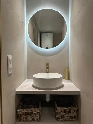 a bathroom with a white sink and a mirror at Appartement cosy au coeur du vieux Nice in Nice