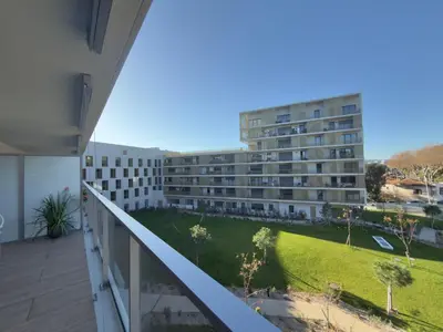 an apartment balcony with a view of a building at L'Elydris - Piscine Wifi Rooftop in Saint-Laurent-du-Var