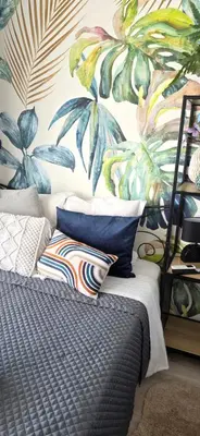 a bedroom with a mural of plants on the wall at Luxe Apartements Azur in Nice
