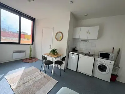 a kitchen with a table and chairs in a room at Bright studio in Nice - Mobility lease only - WIFI in Nice