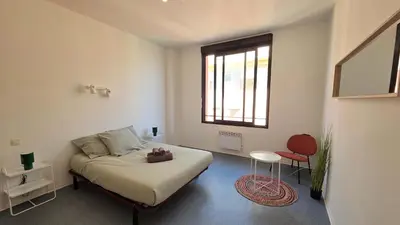 a bedroom with a bed and a table and a window at LX137 1-Bedroom - Downtown Nice - Mobility Lease in Nice