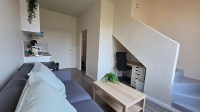 a living room with a couch and a staircase at LX155 Roof terrace city center Mobility Lease in Nice