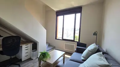 a living room with a couch and a desk and a window at LX155 Roof terrace city center Mobility Lease in Nice