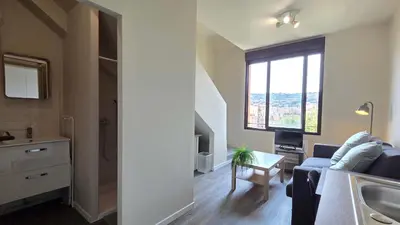 a living room with a couch and a table and a window at LX155 Roof terrace city center Mobility Lease in Nice
