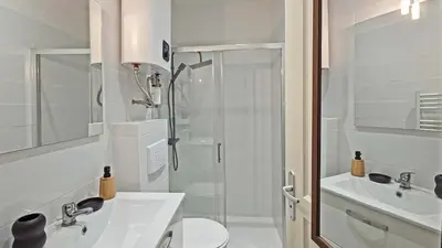 a white bathroom with a shower and a sink at LX148 Charmant studio renove Tram - Bail mobilite in Nice