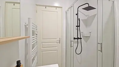 a bathroom with a shower with a shower head at LX149 Studio lumineux fonctionnel - Bail mobilite in Nice