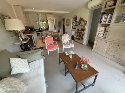 a living room with a couch and a table at Appartement 2 chambres, terrasses, proche mer et commerces à Saint-Jean Cap Ferrat in Saint-Jean-Cap-Ferrat