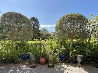 a garden with potted plants and trees and bushes at Appartement 2 chambres, terrasses, proche mer et commerces à Saint-Jean Cap Ferrat in Saint-Jean-Cap-Ferrat