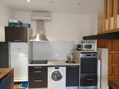 a kitchen with a washing machine and a washer at Studio in Nice