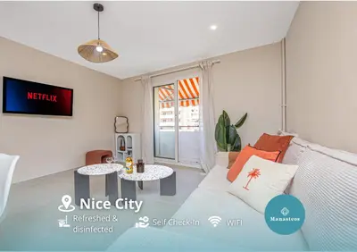a living room with a couch and a table at Nice Saint Roch - Bel appartement rénové - EV in Nice