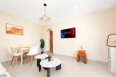 a living room with a table and chairs at Nice Saint Roch - Bel appartement rénové - EV in Nice