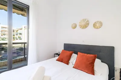 a kitchen and a living room with a table and chairs at Ultra Central 2 Bdr - AC & Balcony in Nice
