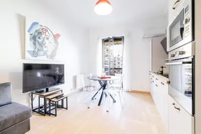 a bedroom with a bed and a large window at Ultra Central 2 Bdr - AC & Balcony in Nice