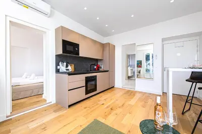 a room with a kitchen and a living room at Bord de mer - Beau 2 pièces rénové - Parking - EX in Èze